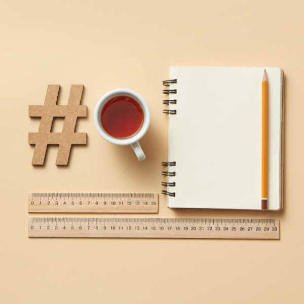 notebook, cup of tea, rulers, hashtag sign