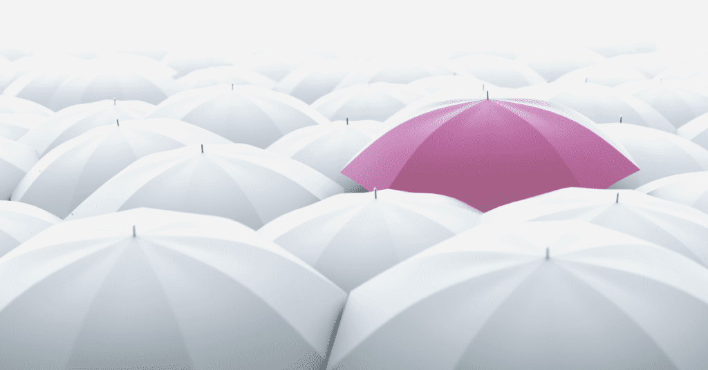 pink umbrella over white umbrellas