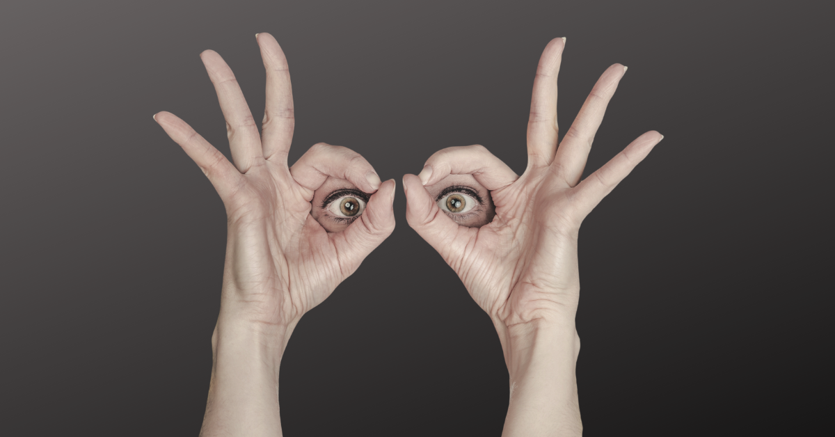 eyes circled by woman's hands